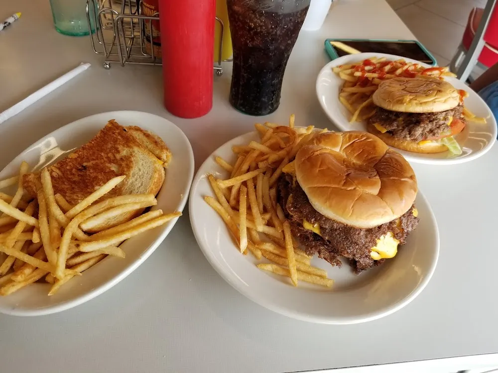 Garlic Burger with Fries and a Drink on a the Side